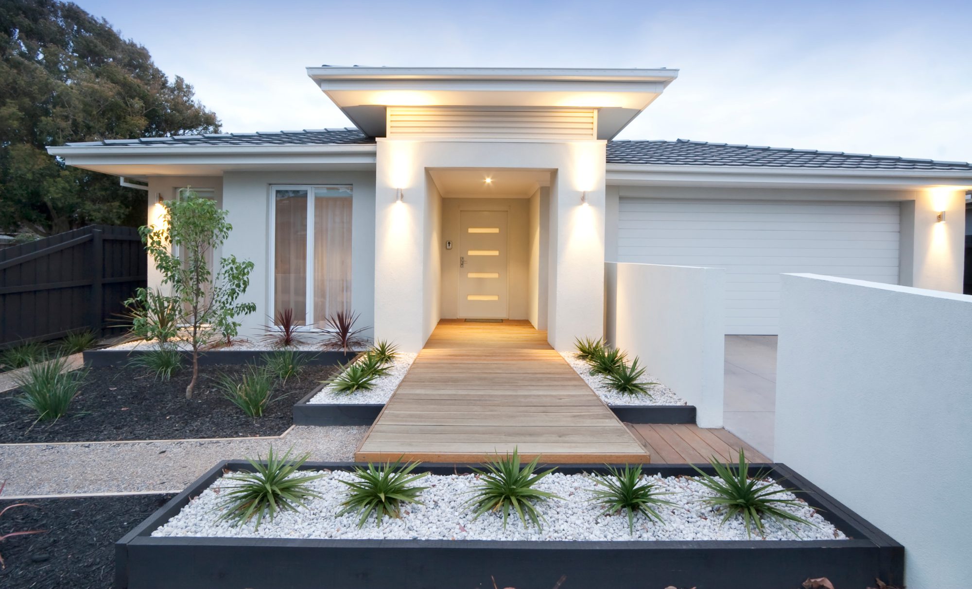 A modern new home with a lit entry